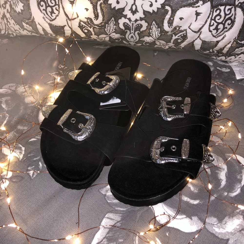 Black sandals with silver buckles